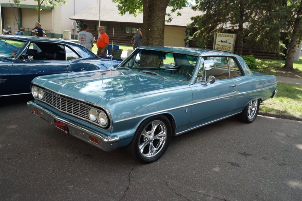 A restored 1964 Chevrolet Chevelle Malibu at a car show.