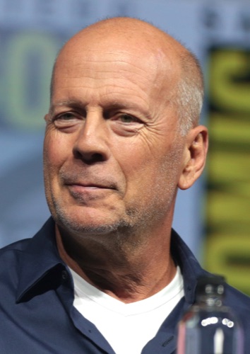 Bruce Willis speaking at a convention, 2018.